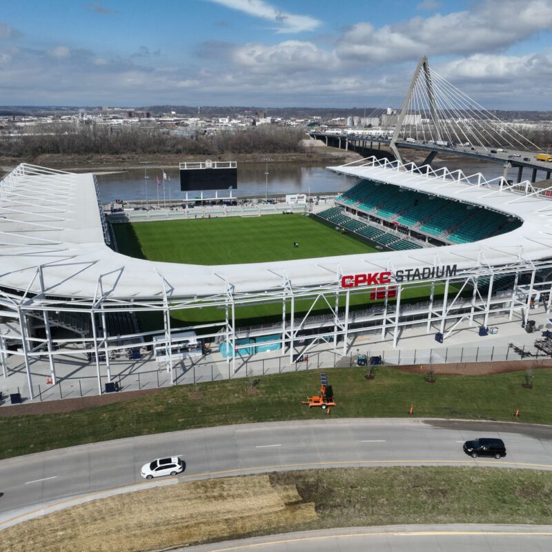 CPKC Stadium aerial near river, bridge, cityscape, and cars.