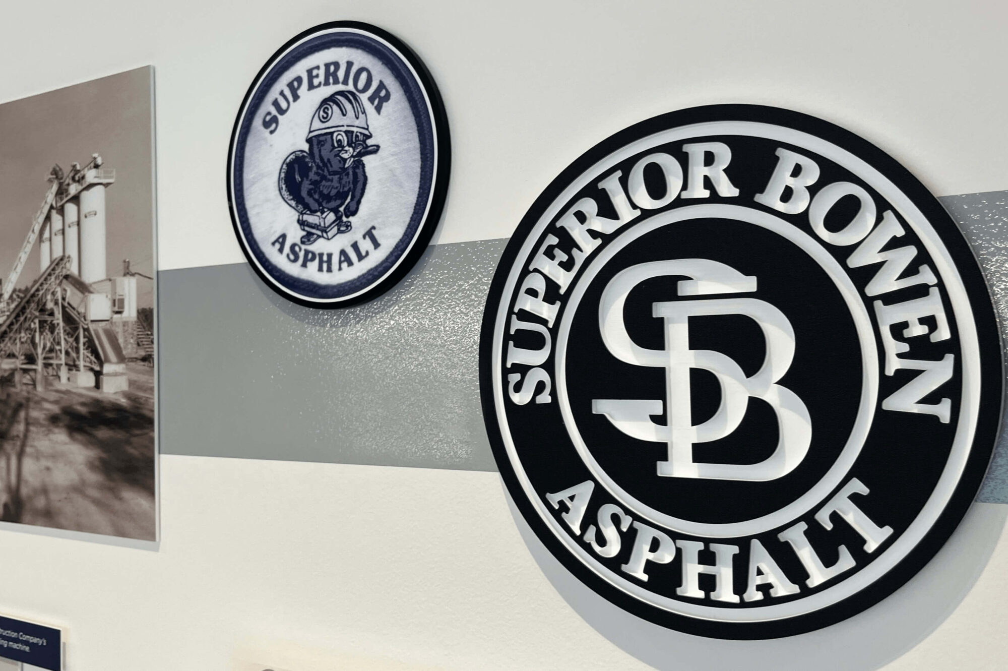 Two Superior Asphalt logos beside black-and-white industrial facility photo.