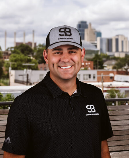Man in Superior Bowen gear stands outside, city skyline behind.