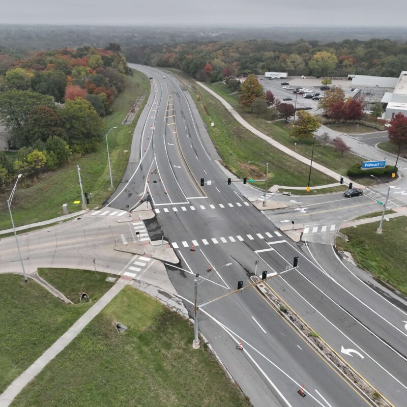 Aerial view of busy intersection with signals and crosswalks.