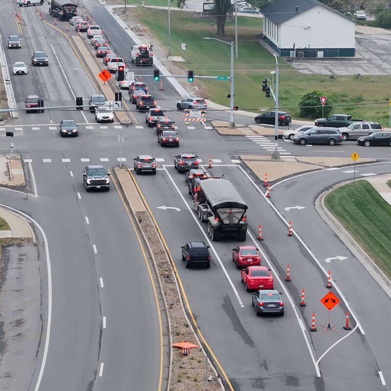 Aerial view of busy intersection with cones and waiting cars.
