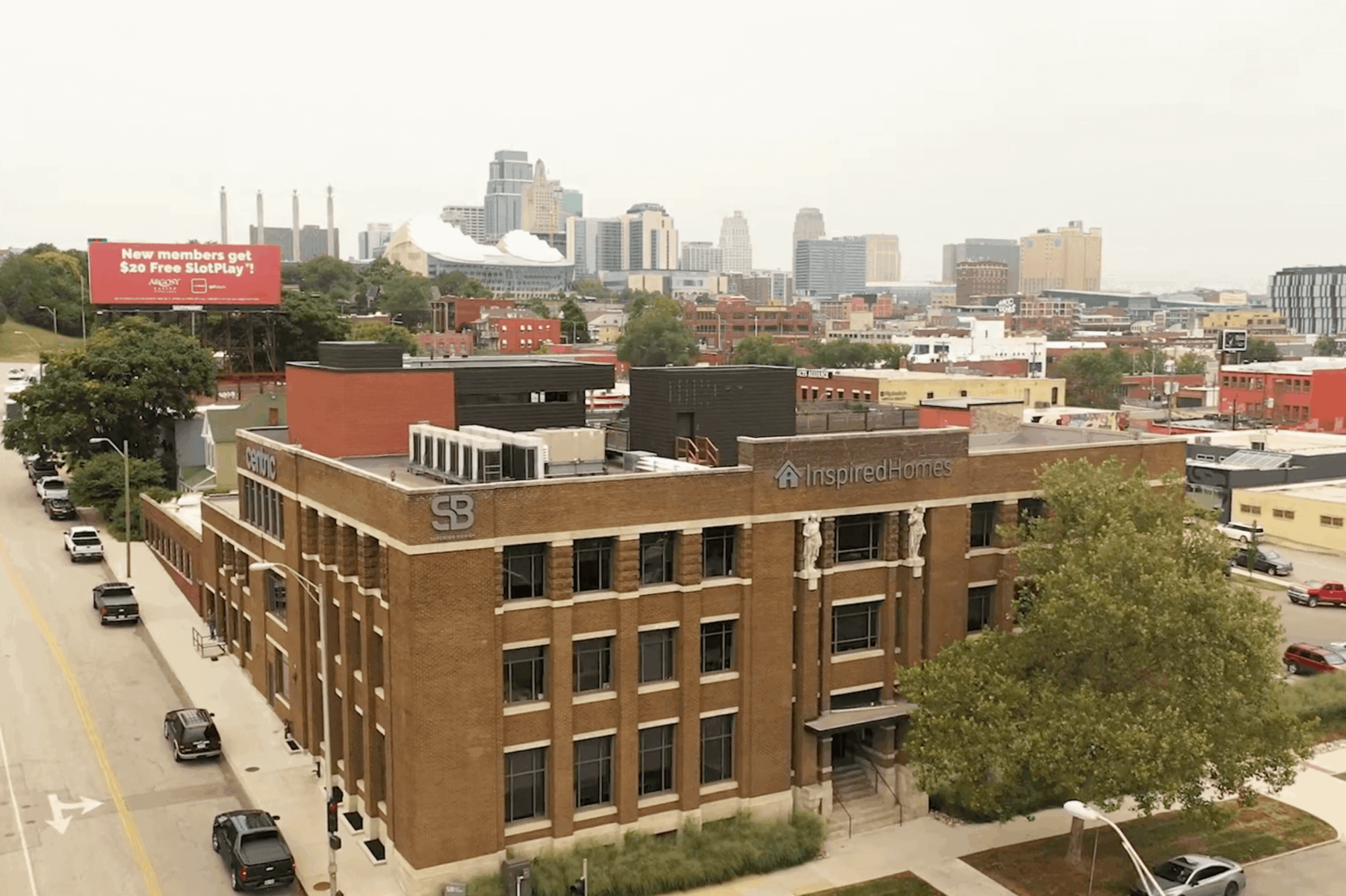 Three-story brick building with SB and Inspired Home signs.